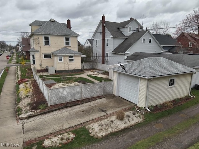 252 W Summit St, Alliance, OH 44601 - back of house featuring driveway, a garage, roof with shingles, and a chimney
