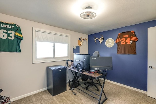 carpeted home office with baseboards