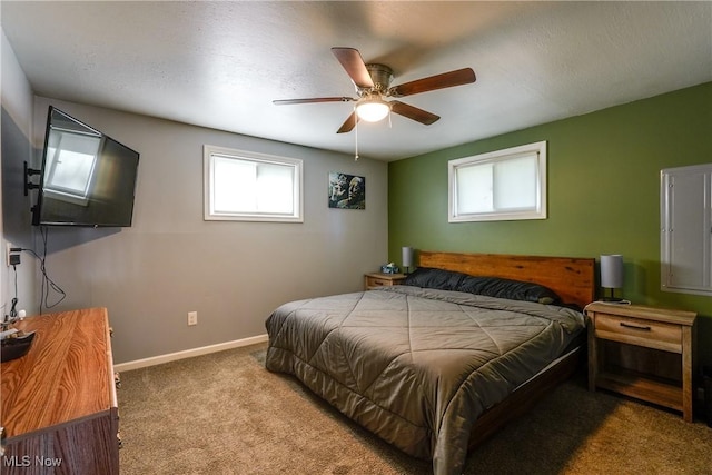 bedroom featuring baseboards, a ceiling fan, and carpet