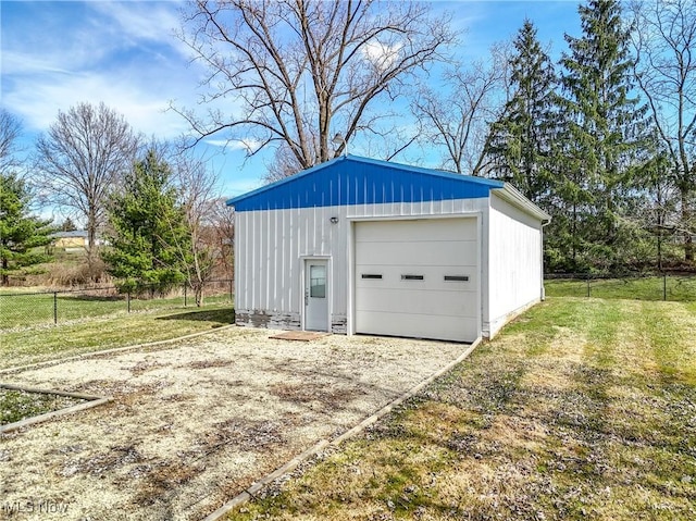 detached garage with driveway and fence