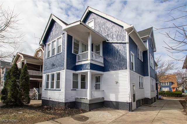 view of side of property with a balcony