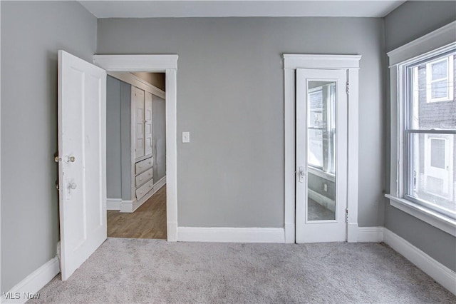 empty room featuring baseboards and carpet floors