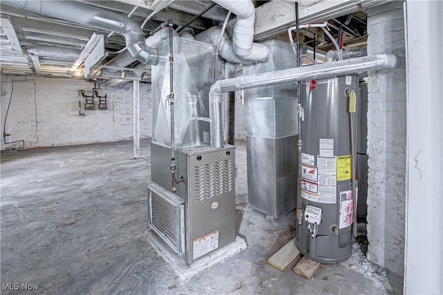utility room featuring heating unit and gas water heater