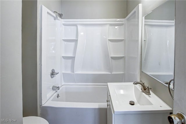 bathroom with bathing tub / shower combination, toilet, and vanity