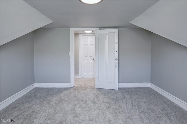 bonus room featuring carpet floors, baseboards, and lofted ceiling
