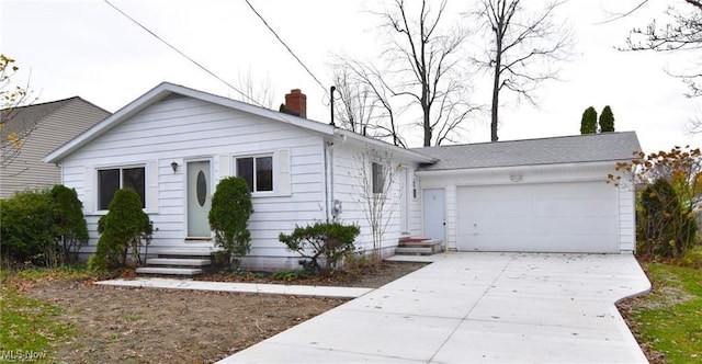 210 Magnolia Ave, Northfield, OH 44067 - view of front facade featuring a chimney, driveway, an attached garage, and entry steps