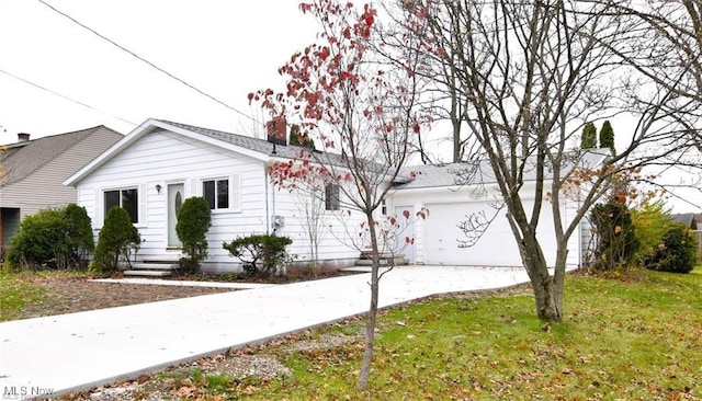 210 Magnolia Ave, Northfield, OH 44067 - view of front facade featuring a front yard, entry steps, a garage, and concrete driveway