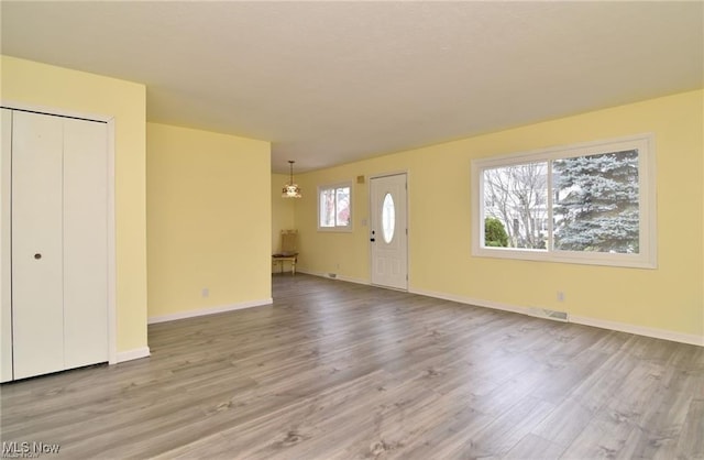 210 Magnolia Ave, Northfield, OH 44067 - foyer entrance featuring baseboards, visible vents, wood finished floors, and an inviting chandelier