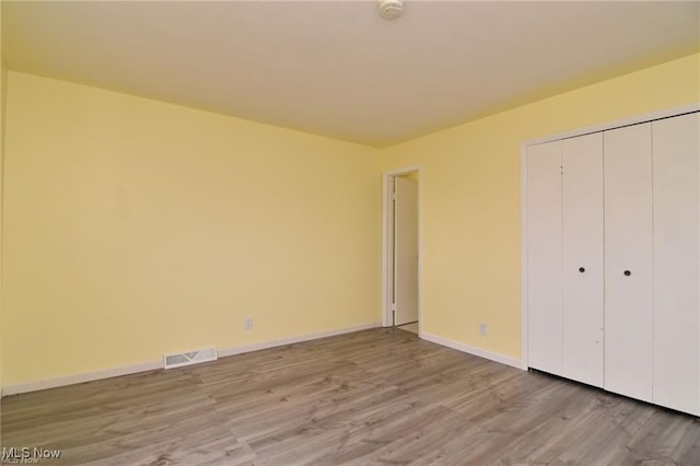 210 Magnolia Ave, Northfield, OH 44067 - unfurnished bedroom with baseboards, a closet, visible vents, and light wood-style floors