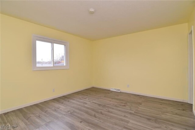 210 Magnolia Ave, Northfield, OH 44067 - empty room featuring baseboards, visible vents, and wood finished floors