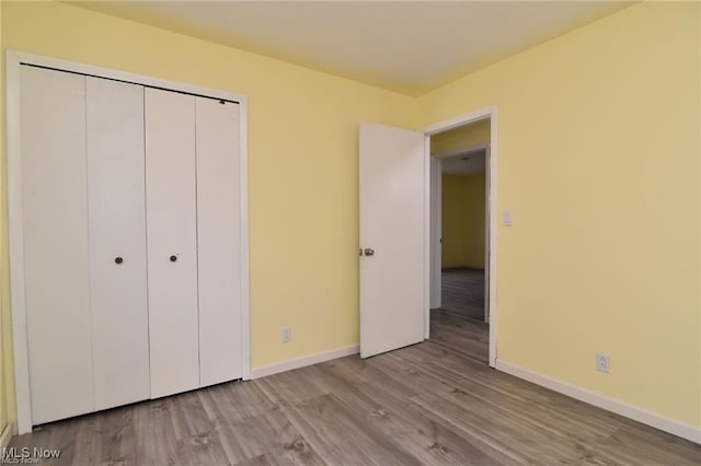 210 Magnolia Ave, Northfield, OH 44067 - unfurnished bedroom with baseboards, wood finished floors, and a closet