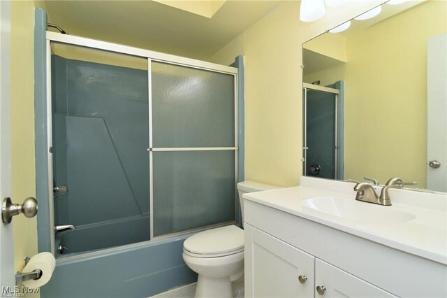 210 Magnolia Ave, Northfield, OH 44067 - full bathroom featuring toilet, bath / shower combo with glass door, and vanity