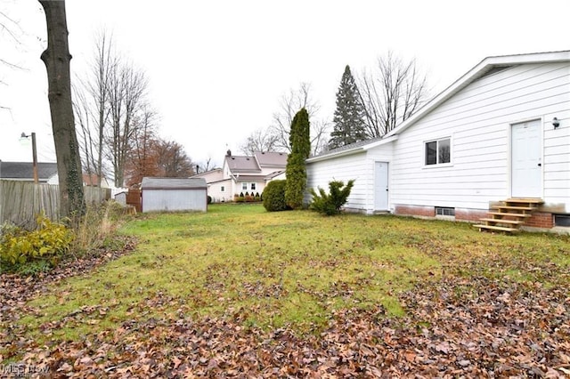 210 Magnolia Ave, Northfield, OH 44067 - view of yard featuring an outbuilding, a storage unit, fence, and entry steps