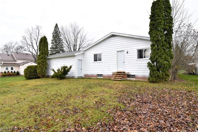 210 Magnolia Ave, Northfield, OH 44067 - back of house featuring a lawn and entry steps