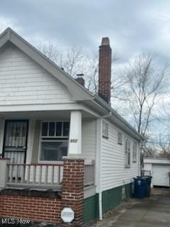 952 Whitby Rd, Cleveland Heights, OH 44112 - view of side of home with covered porch and a chimney