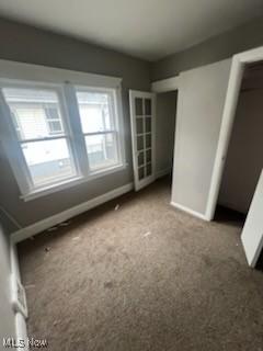 952 Whitby Rd, Cleveland Heights, OH 44112 - unfurnished bedroom with baseboards and carpet flooring