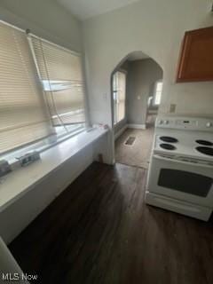 952 Whitby Rd, Cleveland Heights, OH 44112 - kitchen featuring white electric range oven, light countertops, brown cabinets, arched walkways, and dark wood-style floors