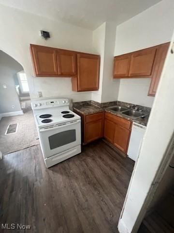 952 Whitby Rd, Cleveland Heights, OH 44112 - kitchen featuring a sink, brown cabinets, dark wood-style floors, white appliances, and arched walkways