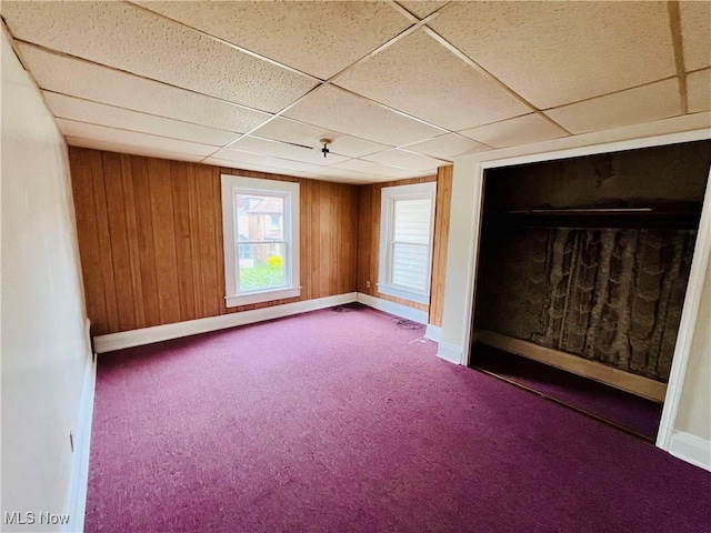 406 Grant St, Newell, WV 26050 - empty room with a paneled ceiling, carpet floors, baseboards, and wooden walls