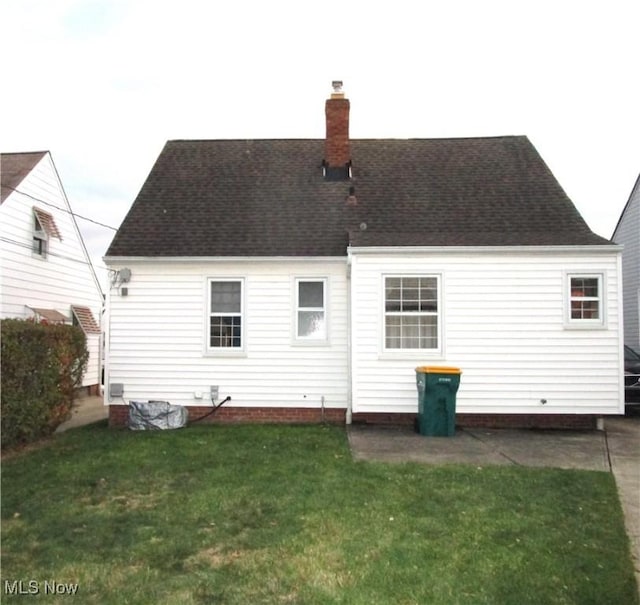 15613 Maplewood Ave, Maple Heights, OH 44137 - back of house with a chimney, a lawn, and roof with shingles