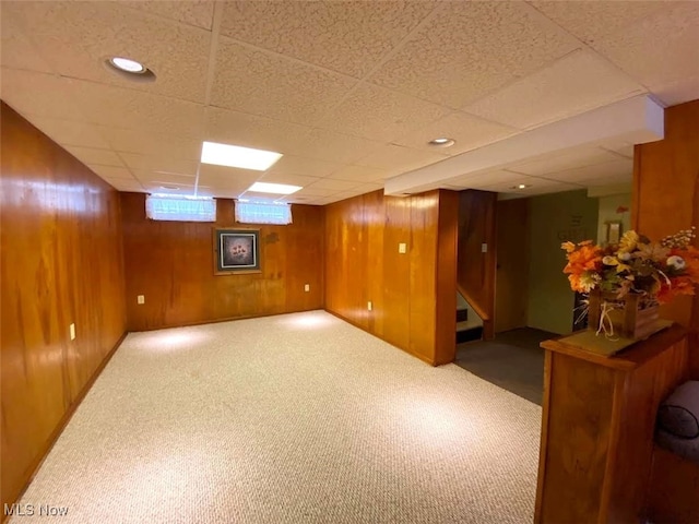15613 Maplewood Ave, Maple Heights, OH 44137 - basement with carpet floors, wood walls, a paneled ceiling, and stairway