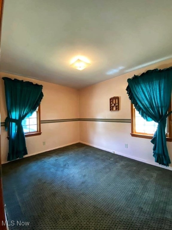 15613 Maplewood Ave, Maple Heights, OH 44137 - spare room with dark colored carpet and baseboards