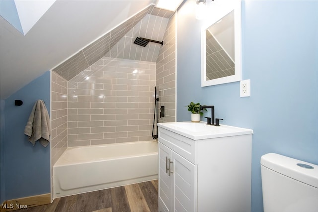 bathroom featuring toilet, vanity, bathtub / shower combination, and wood finished floors