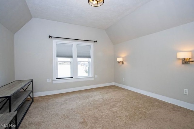 bonus room with baseboards, carpet floors, and vaulted ceiling