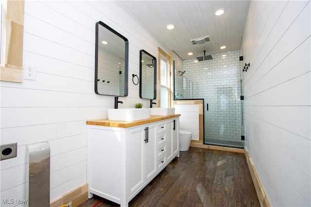full bath featuring a shower stall, wood finished floors, toilet, recessed lighting, and vanity
