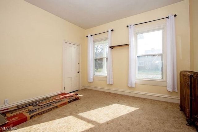 carpeted spare room with radiator