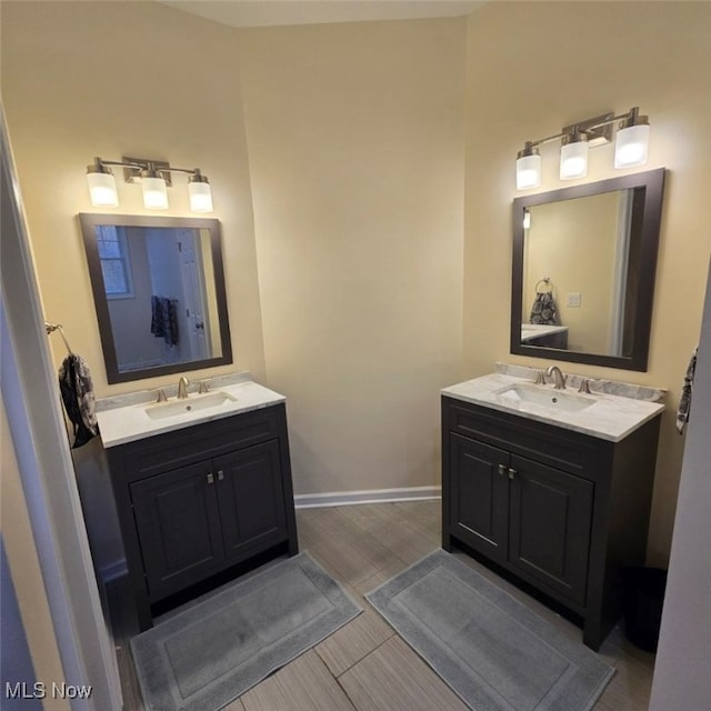 115 Beech St, Kelleys Island, OH 43438 - bathroom with a sink, baseboards, and two vanities