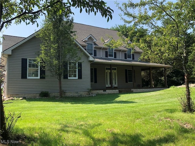 115 Beech St, Kelleys Island, OH 43438 - view of front of home featuring covered porch, a shingled roof, and a front lawn