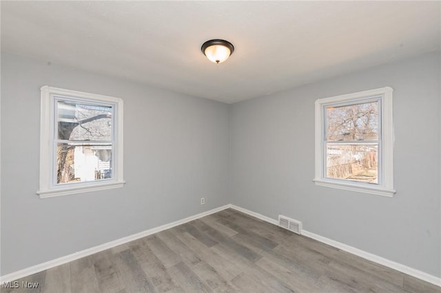 13222 Courtland Ave, Cleveland, OH 44111 - spare room featuring visible vents, baseboards, and wood finished floors