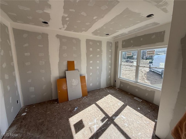 unfurnished room with visible vents