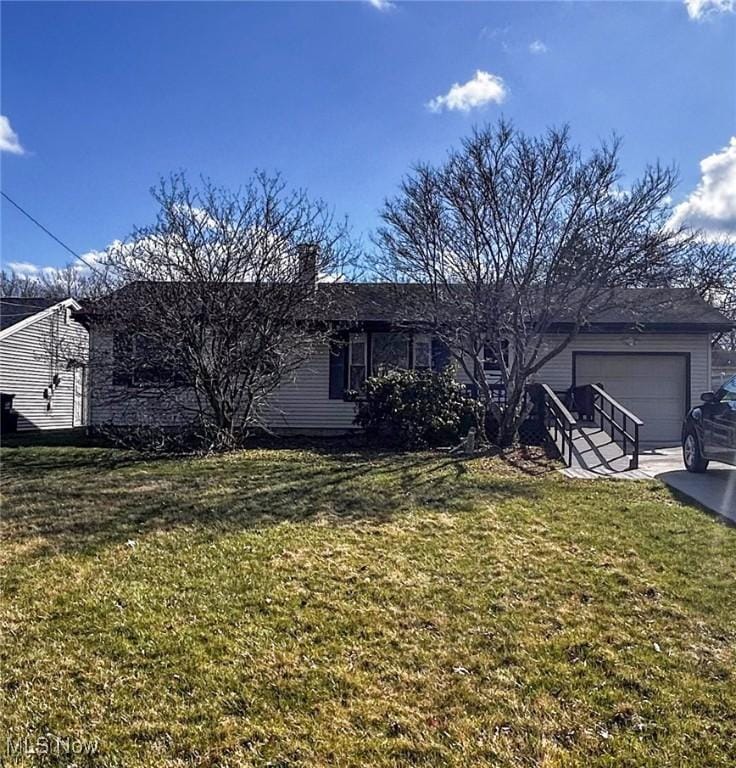 ranch-style house featuring a front yard, driveway, and an attached garage