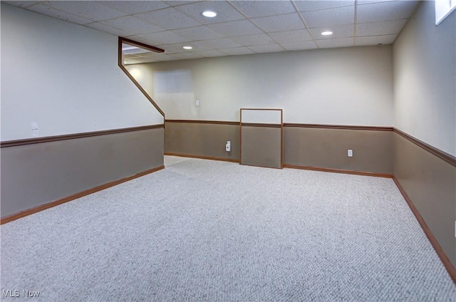 finished below grade area with a paneled ceiling, baseboards, carpet, and recessed lighting