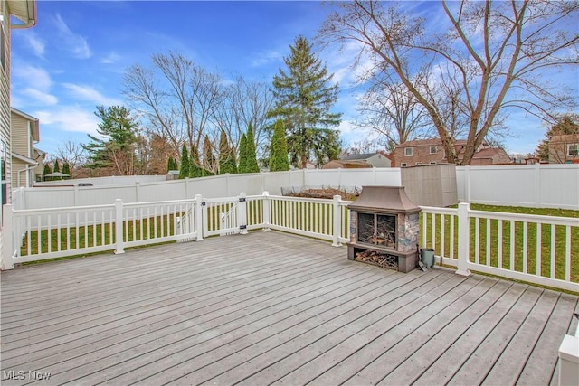 deck with a fenced backyard and a lawn