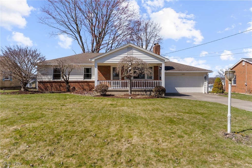 6306 Pawnee Pl, Poland, OH 44514 - single story home with concrete driveway, a front lawn, covered porch, brick siding, and a garage