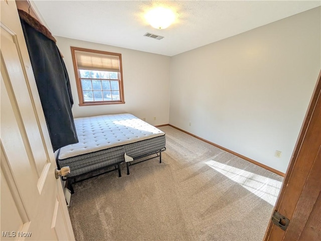 carpeted bedroom with baseboards and visible vents
