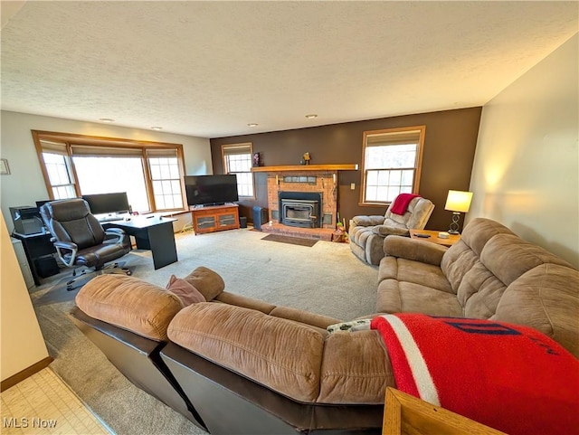 living area featuring plenty of natural light, baseboards, carpet floors, and a textured ceiling
