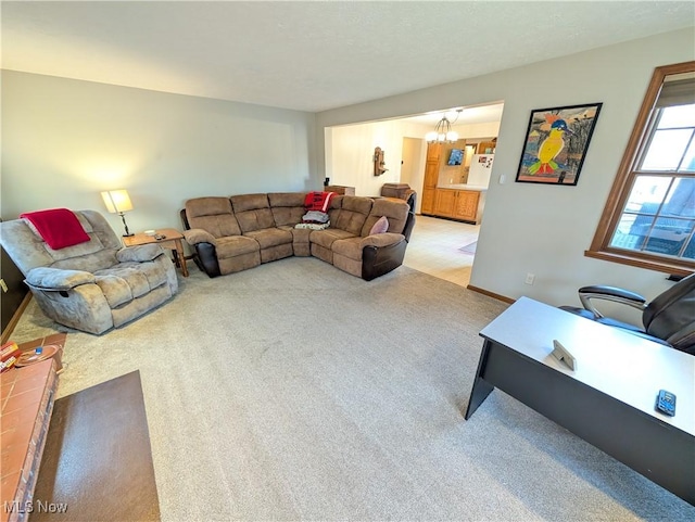 living room featuring an inviting chandelier and light colored carpet