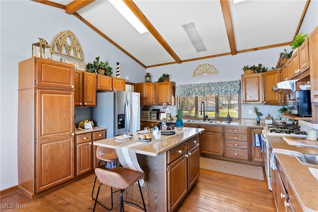 1122 Lake Rd, Conneaut, OH 44030 - kitchen with a sink, beamed ceiling, light wood-style flooring, and appliances with stainless steel finishes