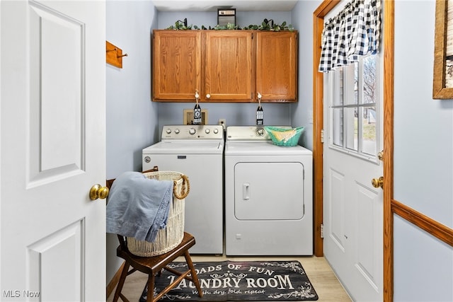 1122 Lake Rd, Conneaut, OH 44030 - laundry room featuring cabinet space, light wood-type flooring, and washer and dryer
