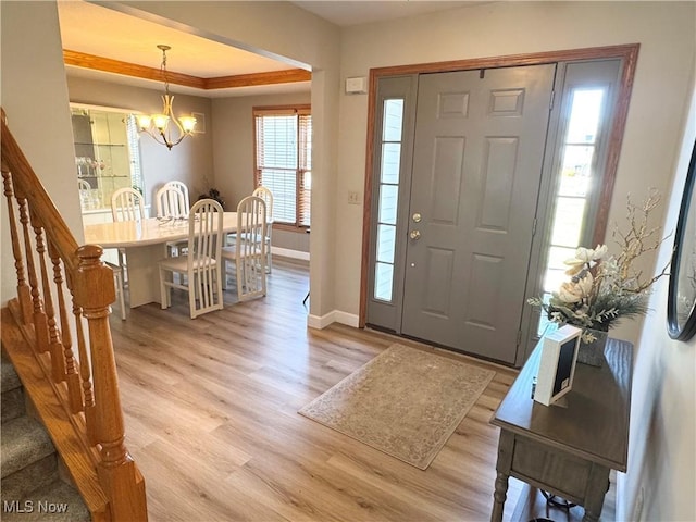 33 Mallards Xing, Canfield, OH 44406 - foyer entrance with a chandelier, a raised ceiling, baseboards, and light wood finished floors