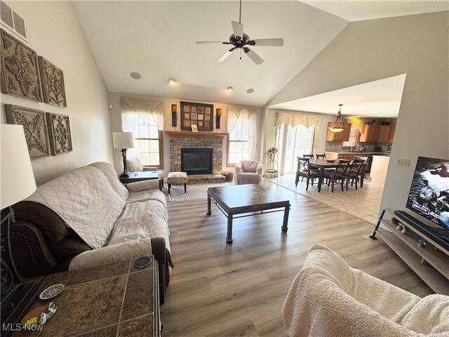 33 Mallards Xing, Canfield, OH 44406 - living room featuring high vaulted ceiling, visible vents, light wood finished floors, a fireplace, and a ceiling fan