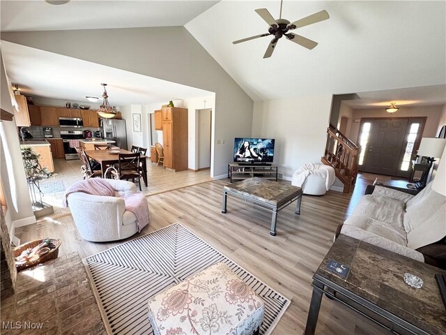 33 Mallards Xing, Canfield, OH 44406 - living room with baseboards, high vaulted ceiling, light wood-style floors, and ceiling fan
