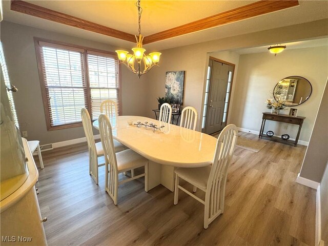 33 Mallards Xing, Canfield, OH 44406 - dining space featuring baseboards, light wood-style flooring, and an inviting chandelier