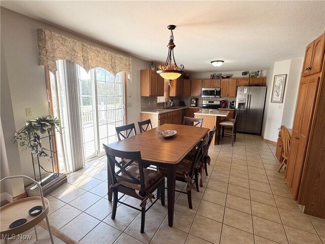 33 Mallards Xing, Canfield, OH 44406 - dining room with light tile patterned flooring, baseboards, and a textured ceiling