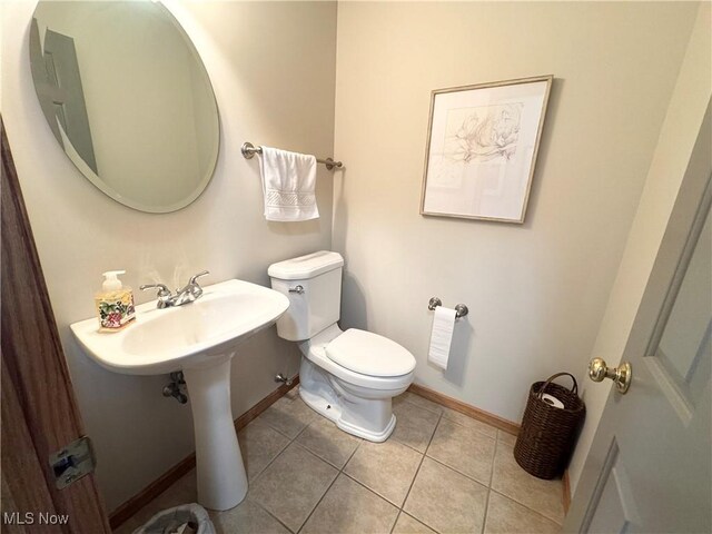 33 Mallards Xing, Canfield, OH 44406 - half bath featuring baseboards, toilet, and tile patterned flooring