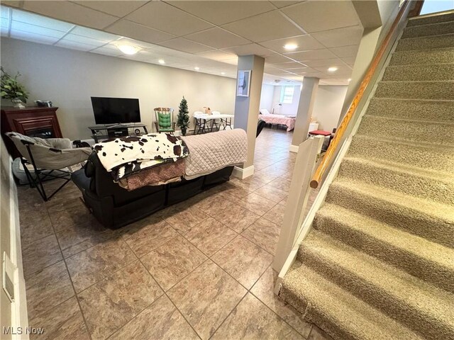 33 Mallards Xing, Canfield, OH 44406 - living room with baseboards, light tile patterned floors, stairway, and a drop ceiling